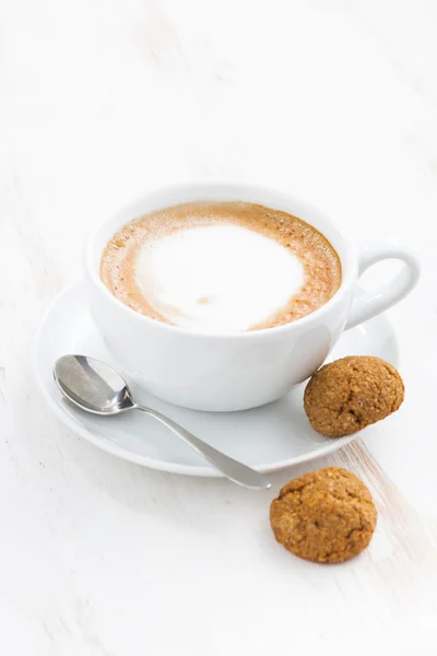 Cup of cappuccino and macaroons, vertical — Stock Photo, Image