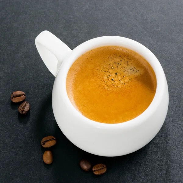 Cup of espresso on a black background, top view — Stock Photo, Image