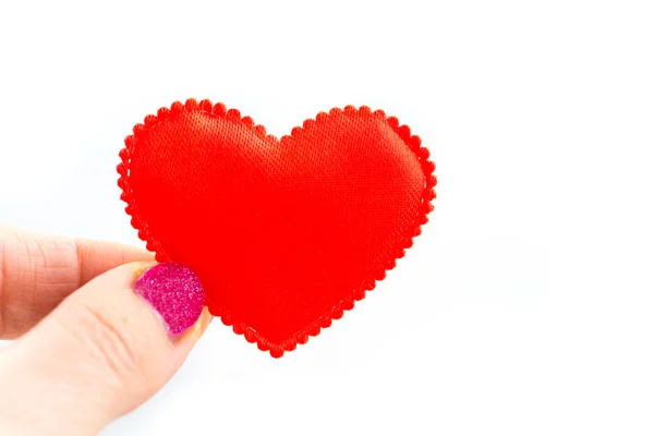 Red heart in the girl 's hand on a white background, isolated — стоковое фото