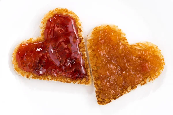 Toasts in heart shape with fruit jam, closeup — Stock Photo, Image