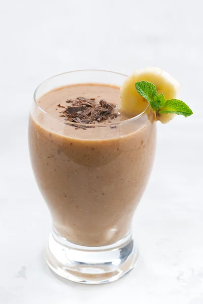 Banana chocolate smoothie in a glass, vertical — Stock Photo, Image