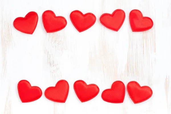 White wooden background with frames of red hearts — Stock Photo, Image