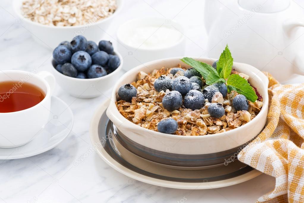 berry crumble with oatmeal in a ceramic form on white table