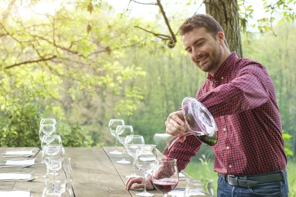 Hombre vierte vino tinto — Foto de Stock