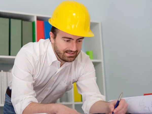 Architect working on his projects papers in the office — Stock Photo, Image