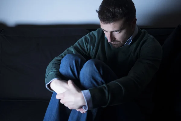 Man depressed  lying on the couch — Stock Photo, Image