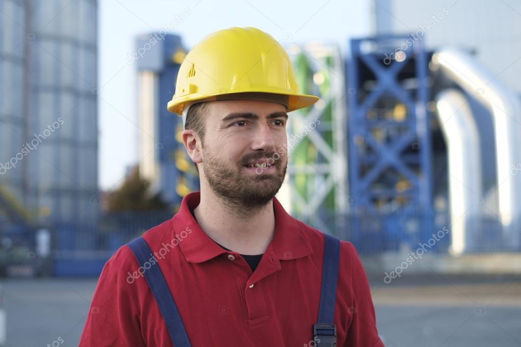 laborer outside a factory working dressed with safety overalls equipment