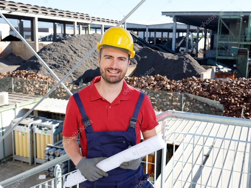 Portrait of factory worker on building site background