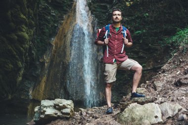 Adamın yanına bir şelale sonra dağ doğa yürüyüşü