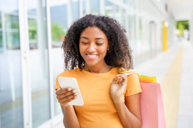 Şehirde gezen ve alışveriş yapan afro kadın