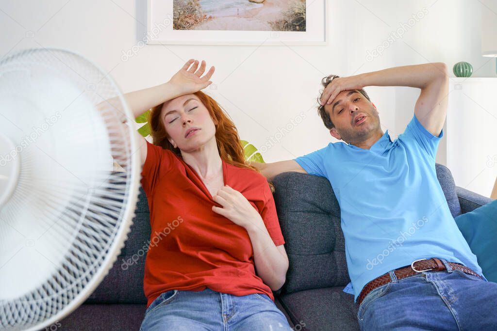 Couple woman suffering for summer heatwave at home