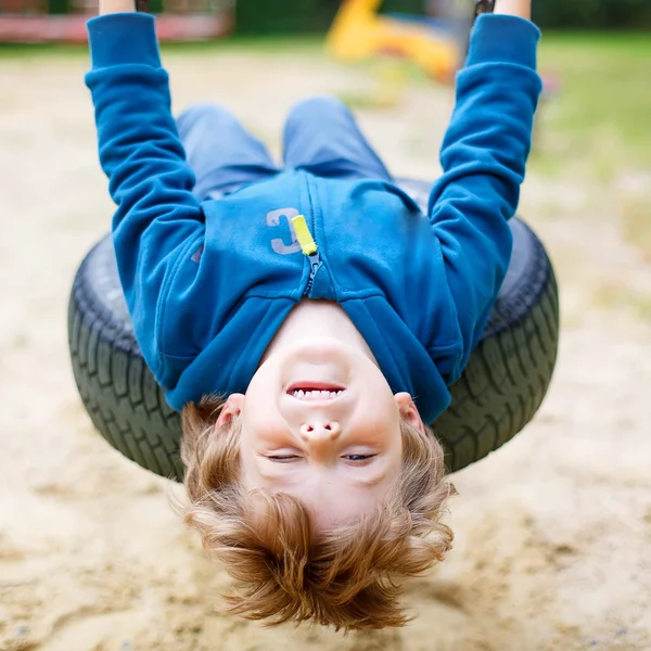 Little kid boy having fun on swing in summer — Stock Photo, Image