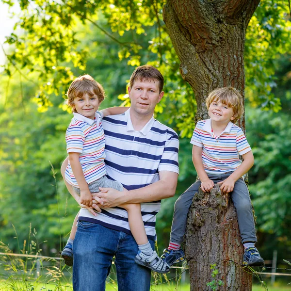 Young dad and his two little sons outdoors summer — 스톡 사진