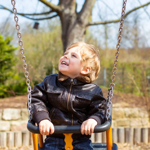 Funny toddler boy having fun on swing — Stock Photo, Image