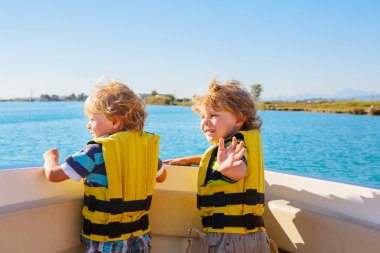 two little kid boys enjoying sailing boat trip