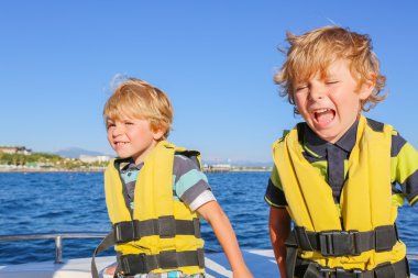 two little kid boys enjoying sailing boat trip