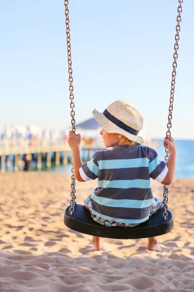 Funny toddler boy having fun on swing — Stock Photo, Image