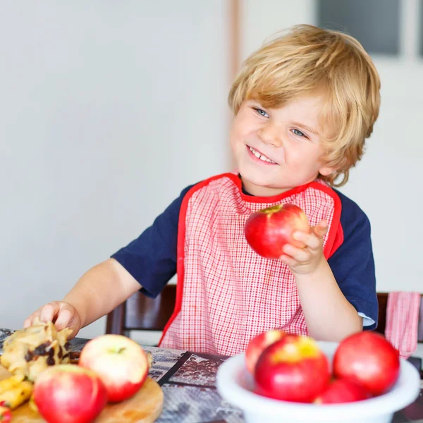 Adorable little boy helping and baking apple pie in home''s kitc — Stock Photo, Image