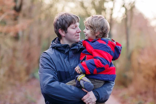 Happy father with his son on arm outdoors — Stock Photo, Image