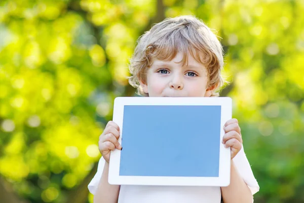 Funny blond kid boy holding tablet pc, — Stock Photo, Image