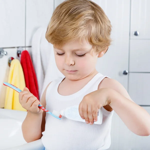 Lovely toddler boy brushing his teeth, indoors — Stock Photo, Image