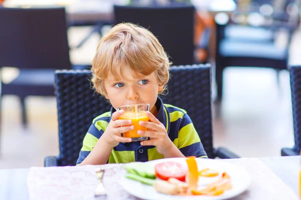 Little kid boy having healthy breakfast in restaurant — Stock Photo, Image