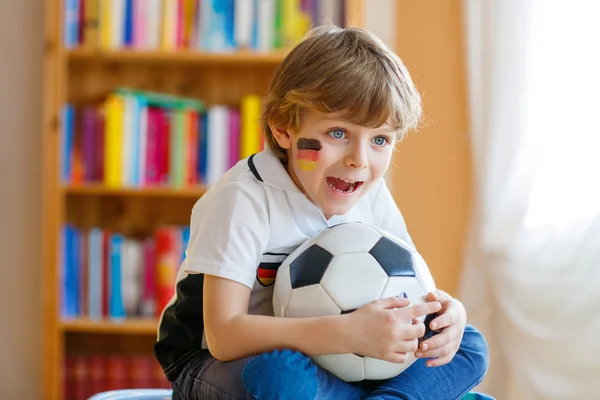 Kid boy watching soccer or football game on tv — Stock Photo, Image