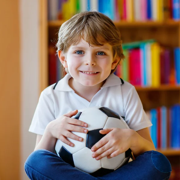 Kid boy watching soccer or football game on tv — Stock Photo, Image