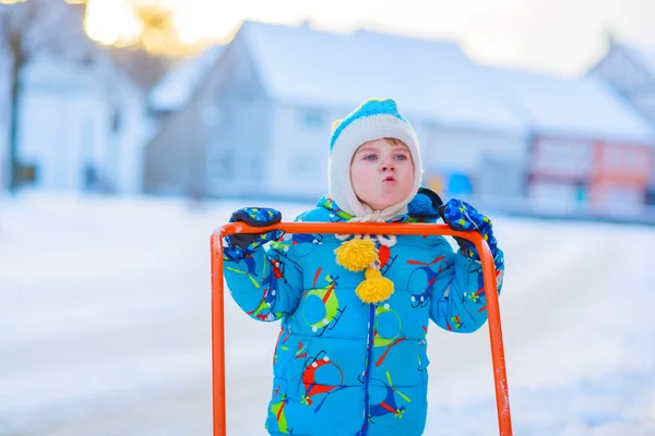 Little kid boy playing with snow in winter, outdoors — Stock Photo, Image