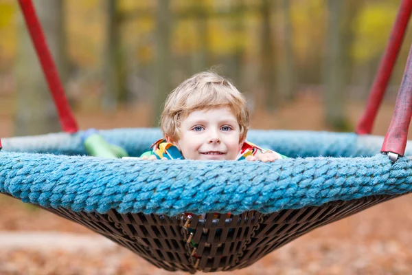 Little kid boy having fun on autumn playground — Stock Photo, Image