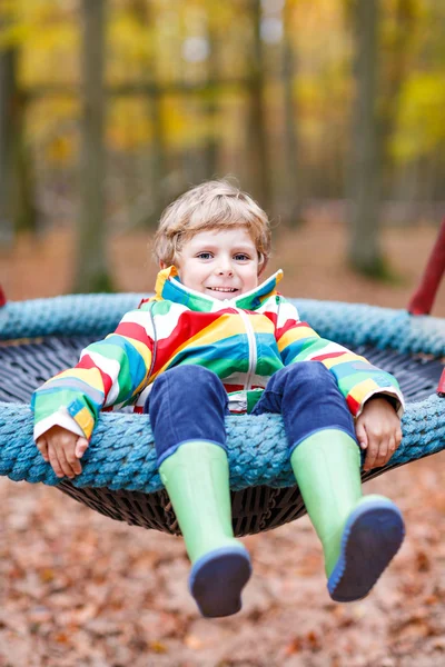 Little kid boy having fun on autumn playground — Stock Photo, Image