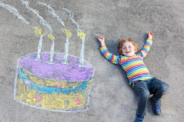 Garoto se divertindo com desenho de bolo de aniversário colorido com chal — Fotografia de Stock