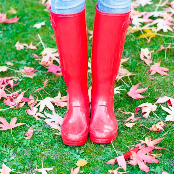 Pernas de mulher jovem em botas de chuva vermelhas . — Fotografia de Stock