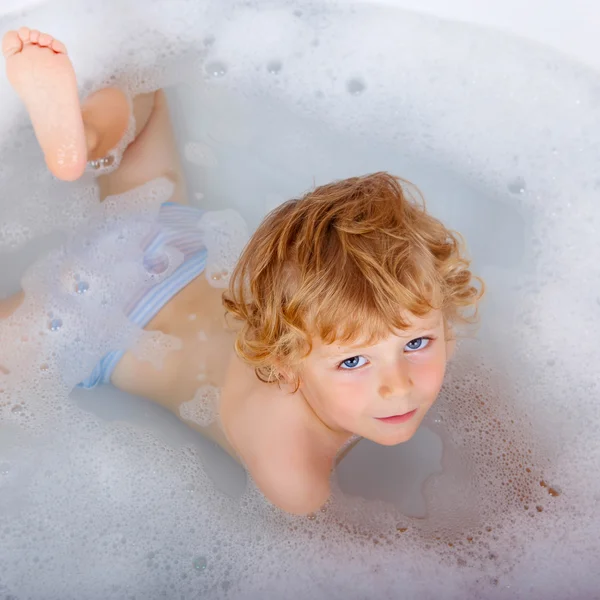 Toddler boy playing in bathtub at home — Stock Photo, Image