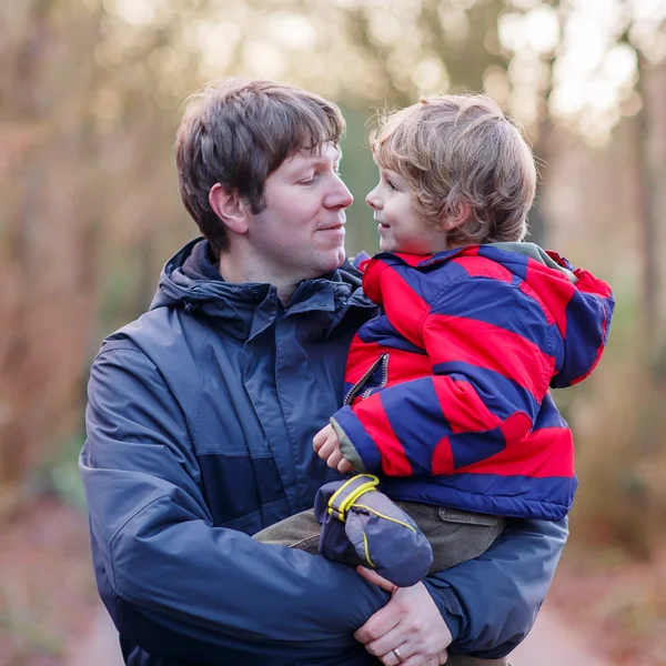 Happy father with his son on arm outdoors — Stock Photo, Image