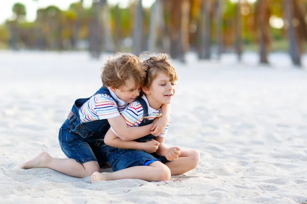 Двое маленьких мальчишек веселятся на пляже — стоковое фото