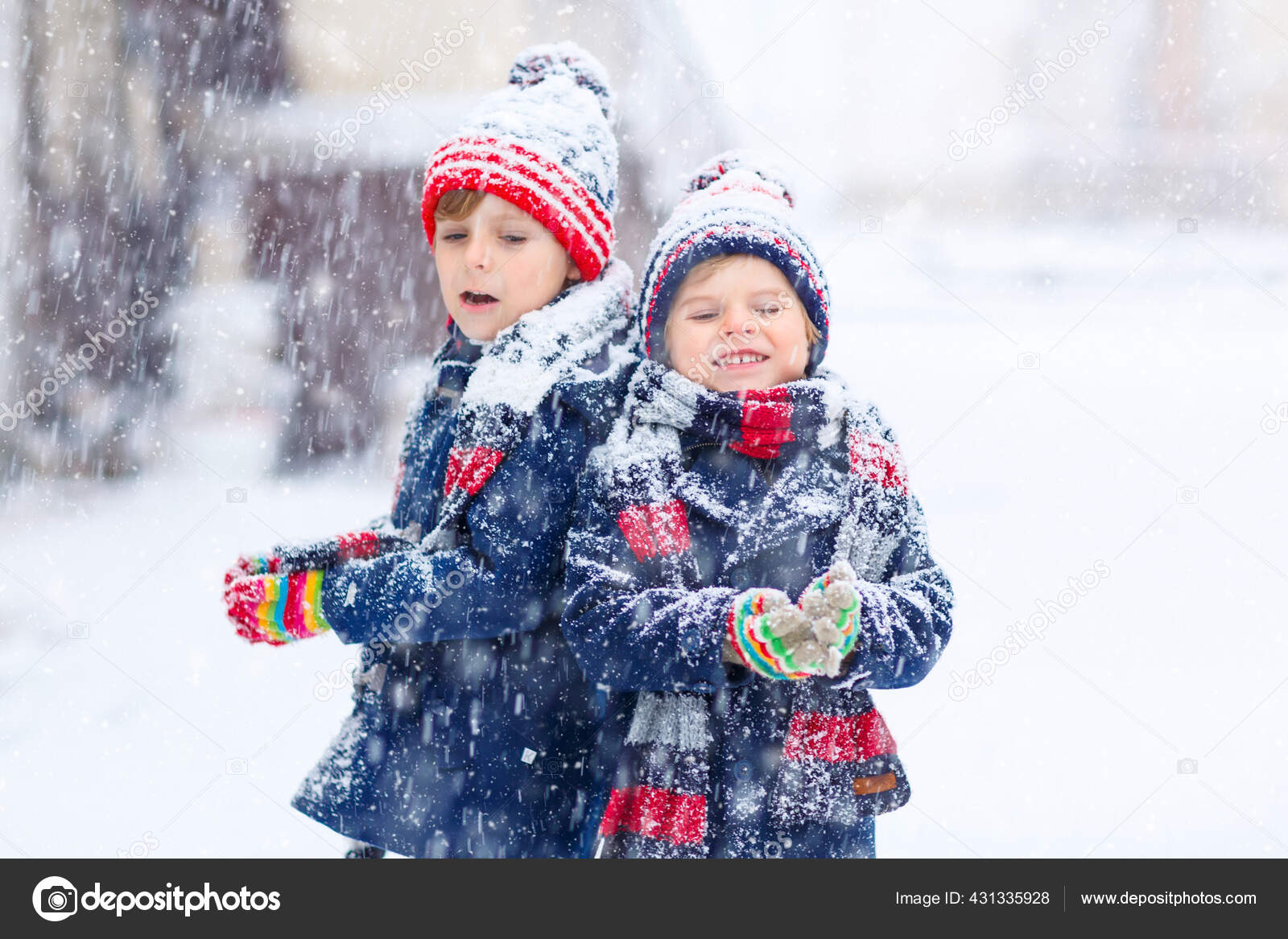 Two little kid boys in colorful fashion clothes playing outdoors