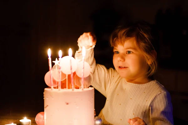 Adorable little toddler girl celebrating fourth birthday. Cute toddler child with homemade princess cake, indoor. Happy healthy toddler blowing 4 candles on cake — ストック写真