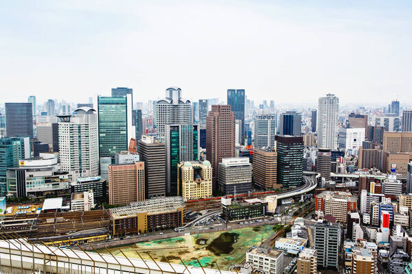 OSAKA,JAPAN - 18 May, 2015: View from above on Osaka city with skyline with skycrapers, highways and parks from top of Osaka castle in Japan. It is the capital city of Osaka Prefecture