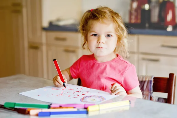 自宅でカラフルな鉛筆でかわいい赤ちゃんの幼児の女の子の絵。フェルトチップペンを使用して、愛らしい健康的な幸せな子供の絵を学ぶ。屋内または保育園で楽しんでいるアクティブな子供. — ストック写真