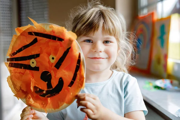 Little preschool girl painting with finger colors making animal tiger craft at home or nursery. Indoor activity with happy creative toddler child, homeschooling with parents — Stock Photo, Image