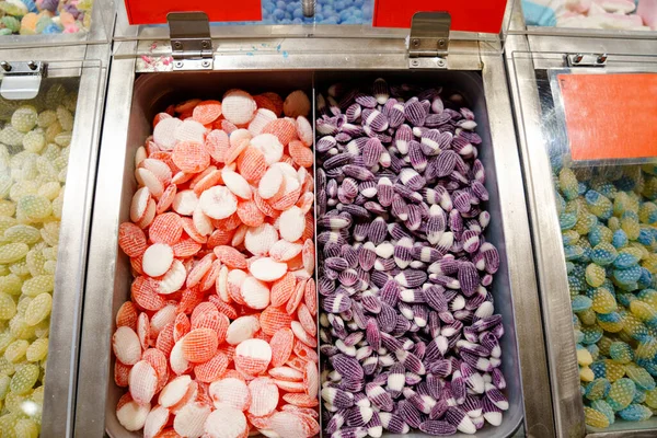 Different lollipops in candy shop. Sweet bonbons with different flavours. — Stock Photo, Image