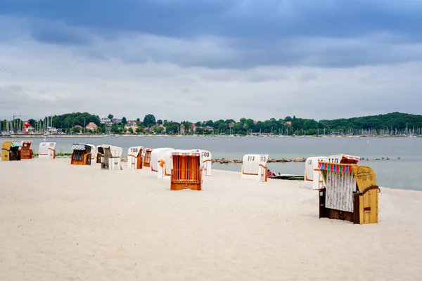 Cadeiras de praia de vime cobertas alemãs tradicionais. Ostsee. Praia de Eckernfoerde destino turístico popular na costa do Mar Báltico, no norte da Alemanha, Schleswig-Holstein. — Fotografia de Stock