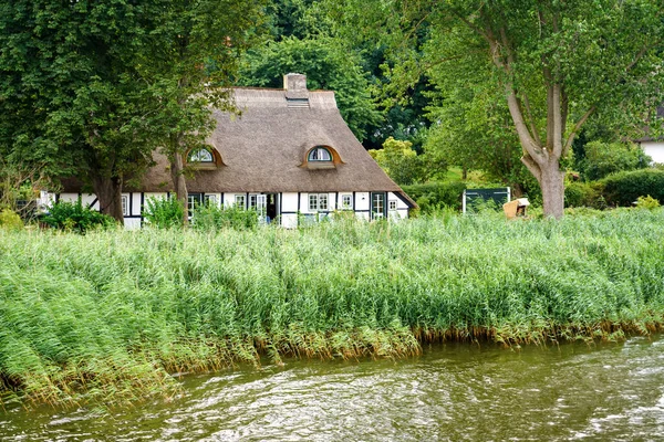 Bela região de Schlei na Alemanha, Schleswig Holstein. Paisagem alemã no verão. Rio Schlei e casas típicas com palha, telhados de cana de água. Sieseby aldeia — Fotografia de Stock