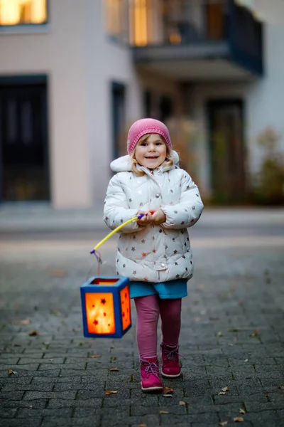 Little kid girl holding selfmade lanterns with candle for St. Martin procession. Healthy cute toddler child happy about children and family parade in kindergarten. German tradition Martinsumzug — Stock Photo, Image