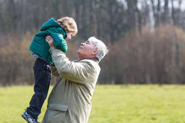 Happy grandfather and his little grandson having fun, outdoors — Stock Photo, Image