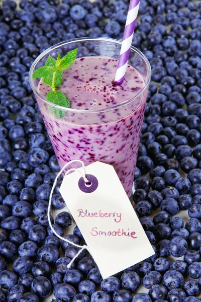 Blueberry smoothie in a glass jar with a straw and sprig of mint — Stock Photo, Image