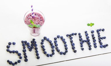 Blueberry smoothie bir cam kavanoza bir saman ve ince dal nane