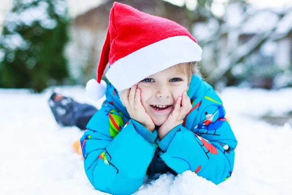 Szczęśliwy chłopiec malucha czeka na Boże Narodzenie santa hat — Zdjęcie stockowe