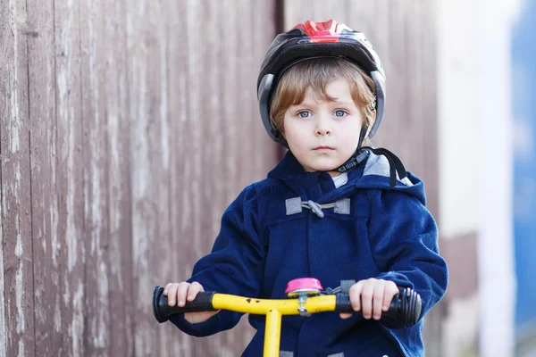 Little boy riding bicycle in village or city — Stock Photo, Image